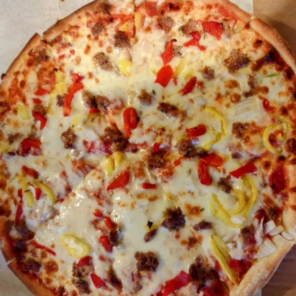 Sainato's at Rivergate Italian pizza with sausage, red peppers, and yellow banana peppers.