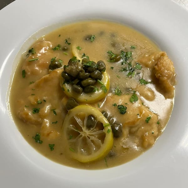 Sainato's Italian chicken piccata with lemon slices, capers, and parsley in a creamy sauce.